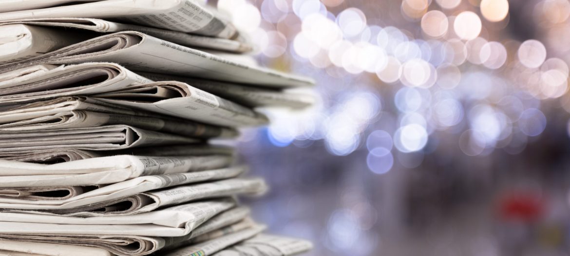 Pile of newspapers stacks on blur background